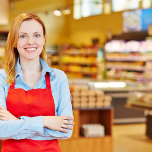 Young happy smiiling woman doing apprenticeship in a supermarket