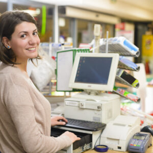 Young woman at cash register in a store